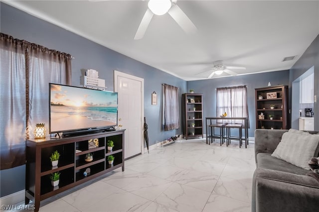 tiled living room with ceiling fan