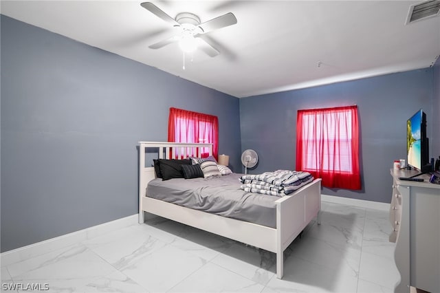 tiled bedroom featuring ceiling fan