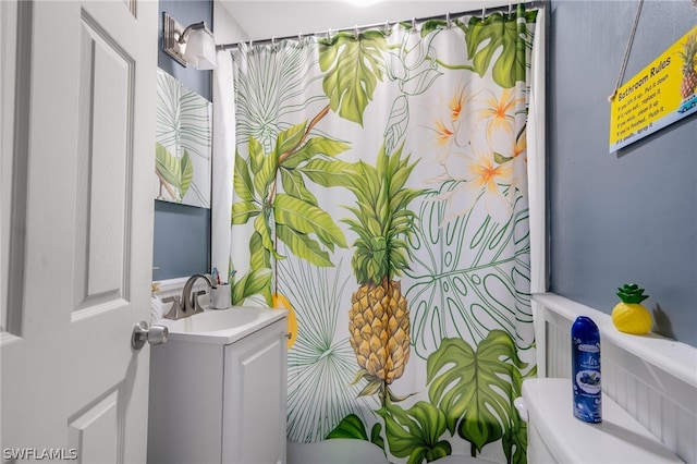 bathroom featuring vanity and toilet