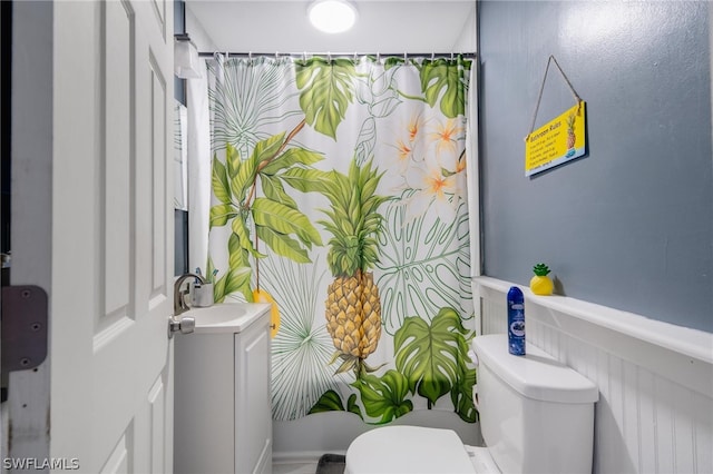 bathroom featuring toilet and vanity