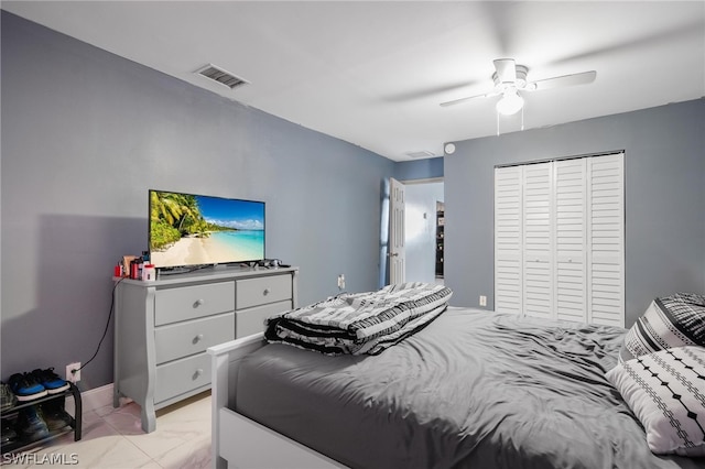 tiled bedroom featuring a closet and ceiling fan