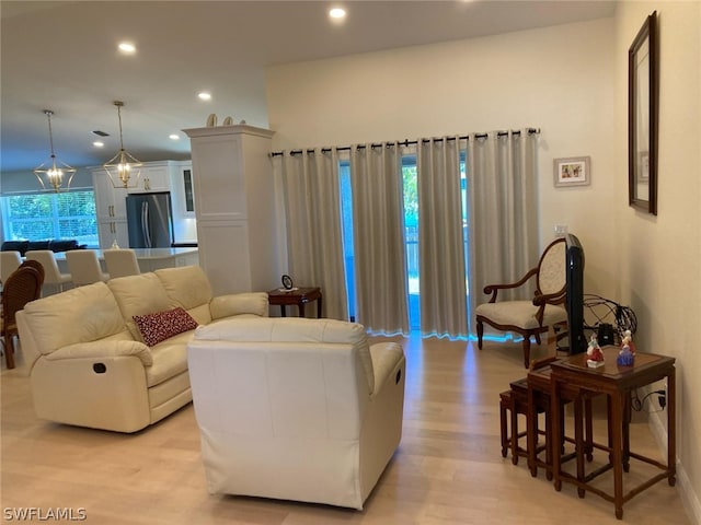 living room featuring a chandelier and light hardwood / wood-style floors