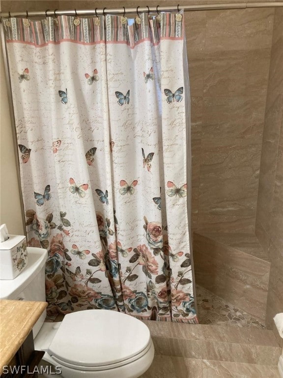 bathroom with vanity, tile floors, and toilet