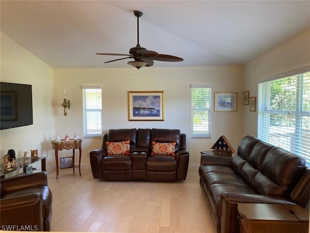 living room with a wealth of natural light, ceiling fan, and light wood-type flooring