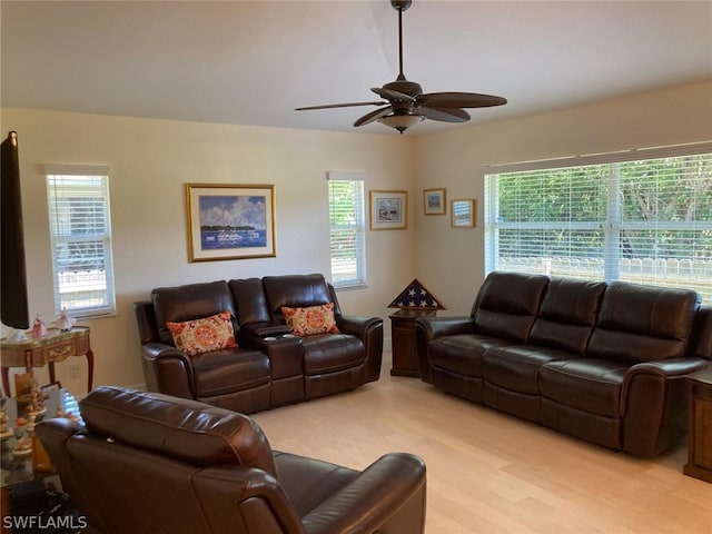 living room featuring light hardwood / wood-style floors and ceiling fan