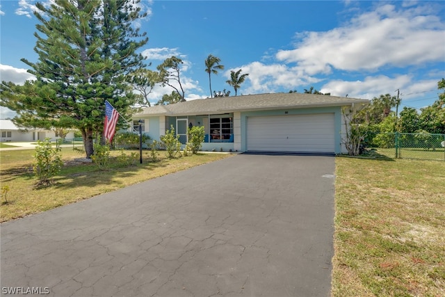 ranch-style home featuring a garage and a front lawn