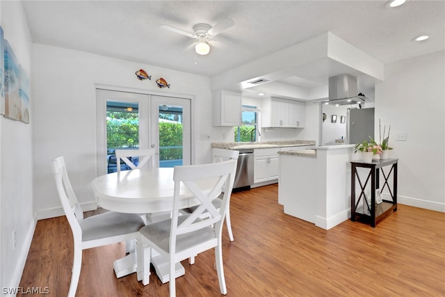 dining room featuring ceiling fan, light hardwood / wood-style flooring, and french doors