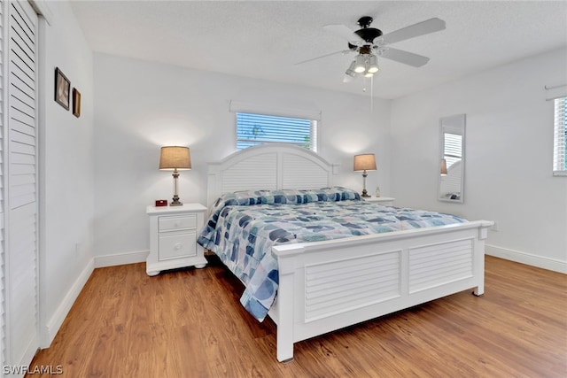 bedroom featuring a textured ceiling, hardwood / wood-style floors, and ceiling fan