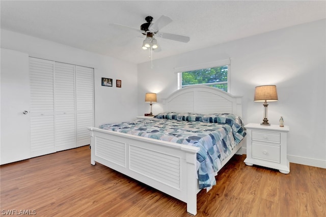 bedroom featuring a closet, ceiling fan, and hardwood / wood-style floors