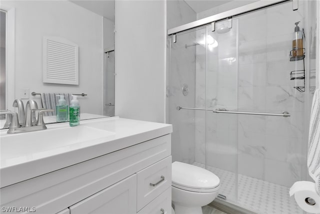 bathroom featuring walk in shower, vanity, and toilet