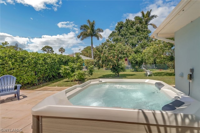 view of pool with a lawn and a patio