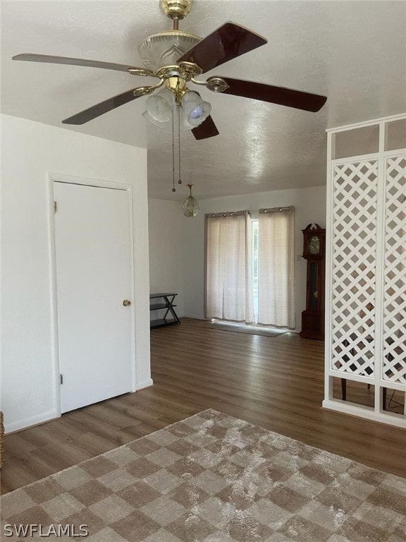 unfurnished room with dark hardwood / wood-style flooring and ceiling fan