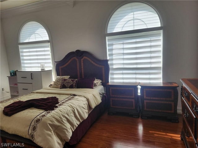 bedroom featuring dark hardwood / wood-style floors and ornamental molding