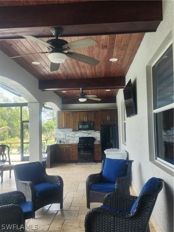 view of patio featuring ceiling fan, area for grilling, and sink