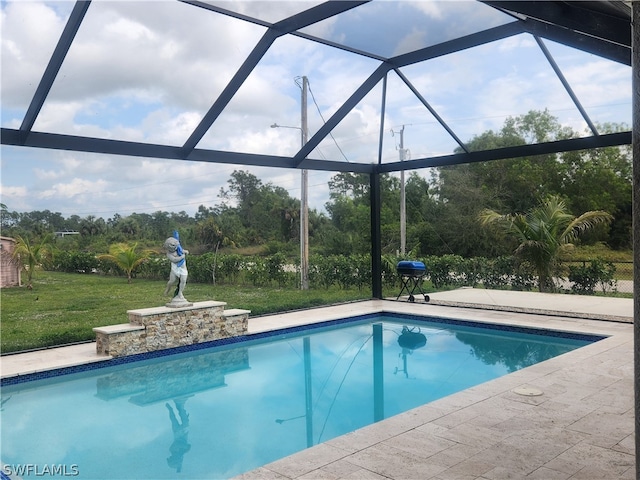 view of pool with a patio and glass enclosure