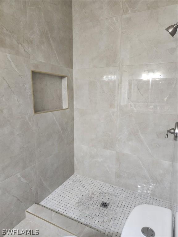 bathroom with tiled shower