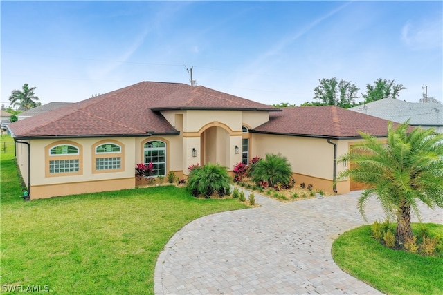 mediterranean / spanish house with a front yard