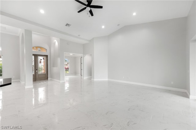 tiled spare room featuring ceiling fan and vaulted ceiling