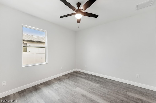 unfurnished room with ceiling fan and dark hardwood / wood-style flooring