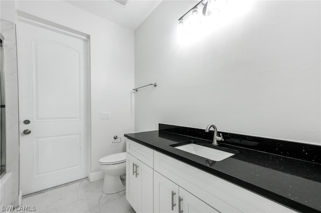 bathroom featuring toilet, tile floors, and vanity