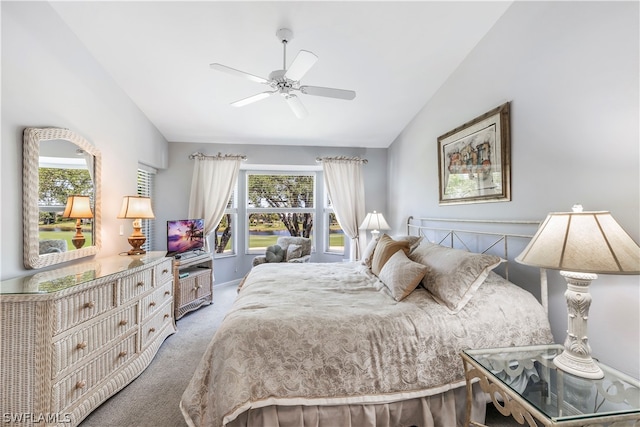 bedroom with vaulted ceiling, multiple windows, carpet, and ceiling fan