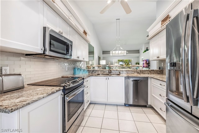 kitchen with white cabinets, tasteful backsplash, stainless steel appliances, and kitchen peninsula