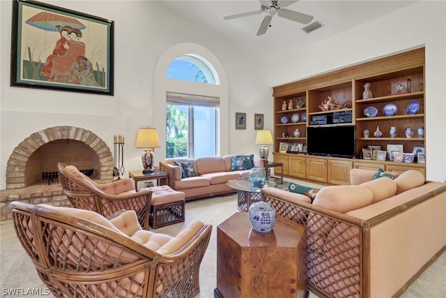 carpeted living room featuring ceiling fan and a fireplace