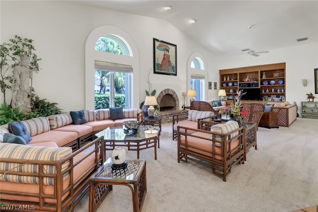 living room with built in shelves, light colored carpet, vaulted ceiling, and ceiling fan