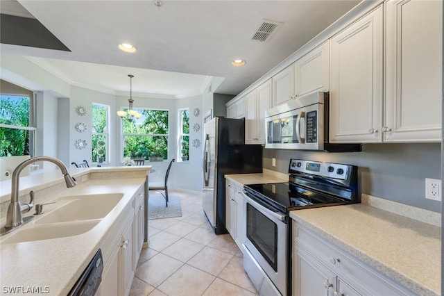 kitchen featuring appliances with stainless steel finishes, ornamental molding, sink, pendant lighting, and white cabinets