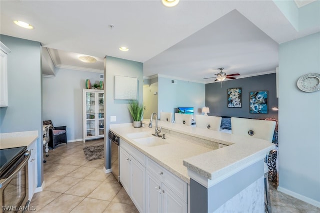 kitchen with stainless steel appliances, white cabinetry, sink, and a kitchen island with sink