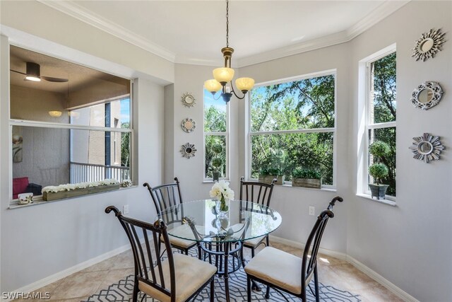 tiled dining space with ceiling fan with notable chandelier and ornamental molding