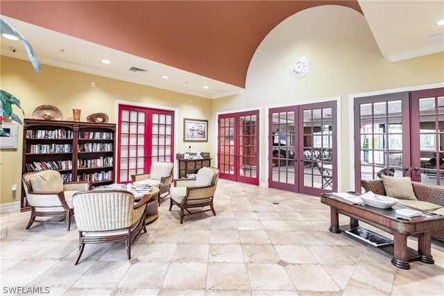 living area featuring french doors and a high ceiling