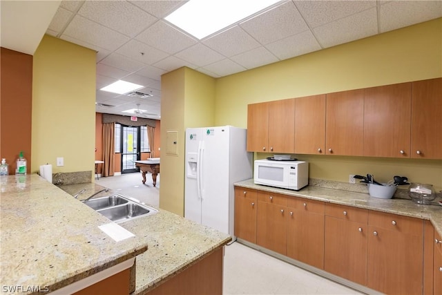 kitchen featuring kitchen peninsula, a drop ceiling, white appliances, sink, and billiards