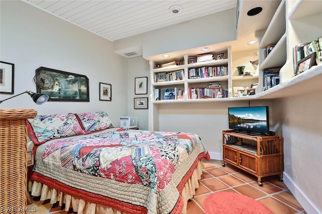 tiled bedroom featuring baseboards and visible vents