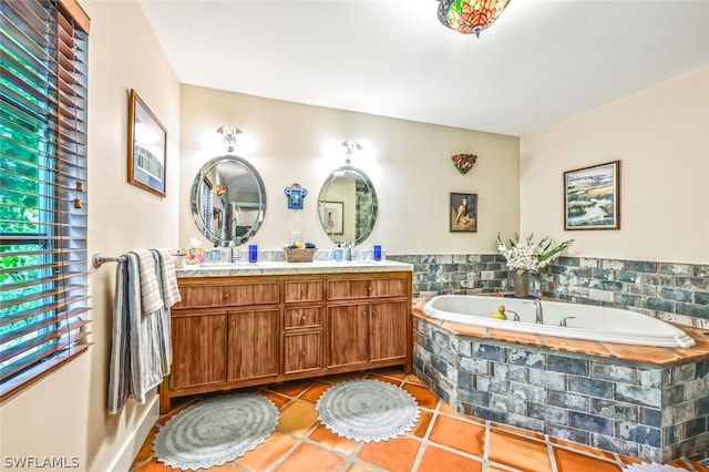 bathroom featuring double vanity, a sink, a bath, and tile patterned floors