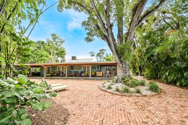 rear view of property featuring a patio area