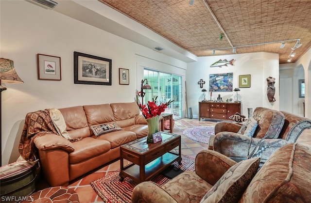 living area with light tile patterned flooring, visible vents, and track lighting