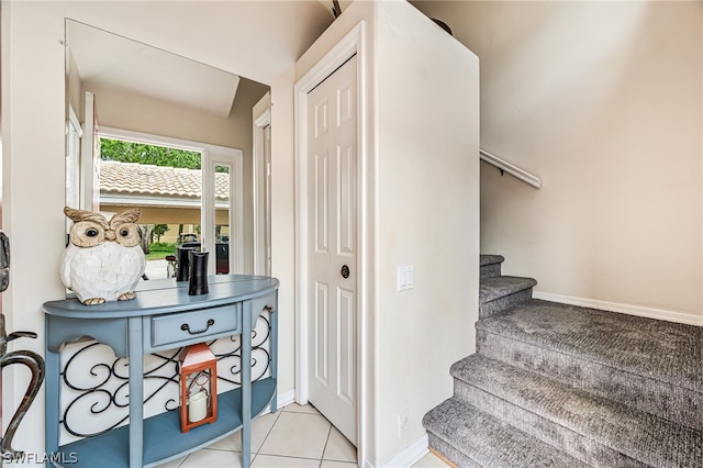 stairway featuring light tile flooring