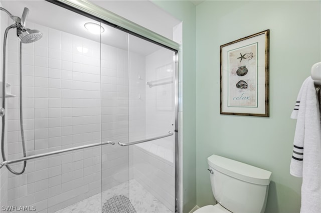 bathroom with an enclosed shower and toilet