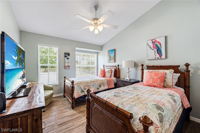 bedroom with light wood-type flooring, ceiling fan, and lofted ceiling