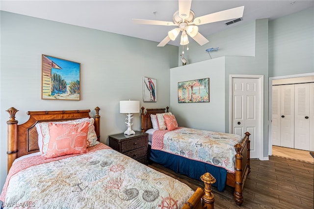 bedroom featuring a closet, dark wood-type flooring, and ceiling fan