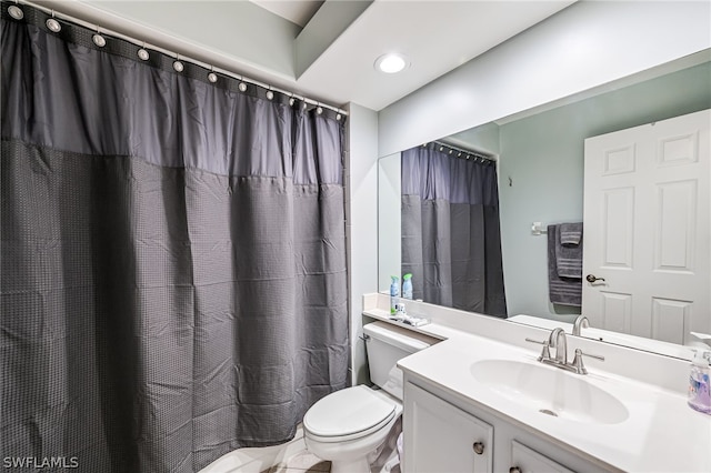 bathroom featuring vanity and toilet