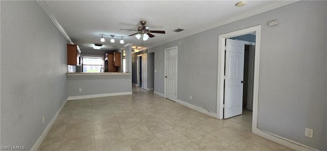 empty room with crown molding, ceiling fan, and light tile patterned flooring