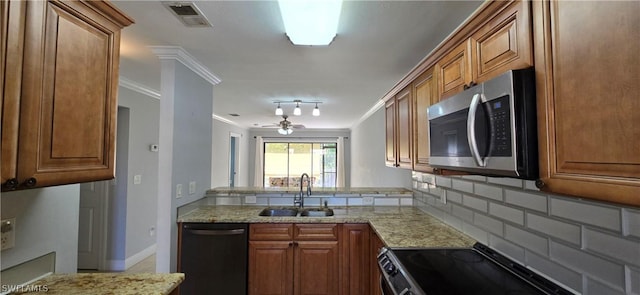 kitchen featuring sink, crown molding, tasteful backsplash, stainless steel appliances, and light stone countertops