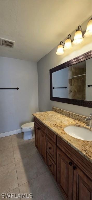 bathroom with vanity, a shower, tile patterned floors, and toilet