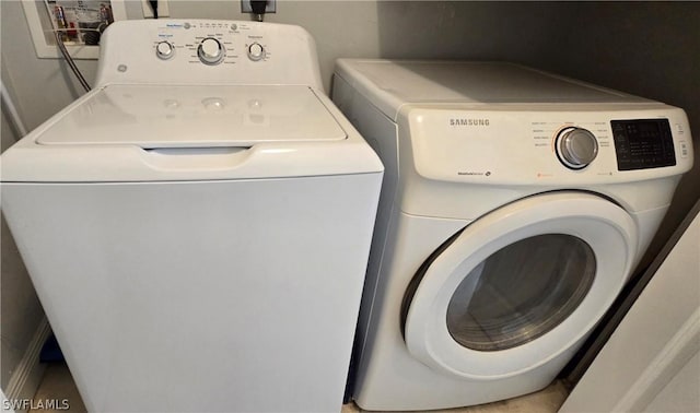 clothes washing area featuring independent washer and dryer