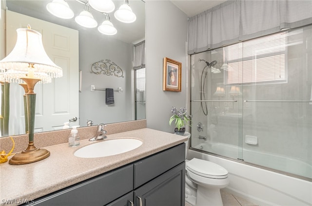 full bathroom featuring tile floors, combined bath / shower with glass door, toilet, and large vanity