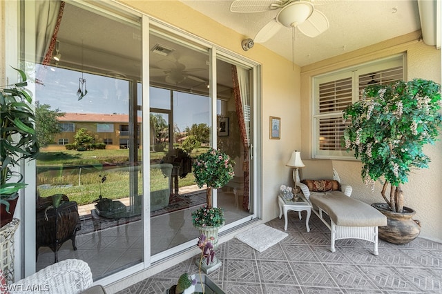 sunroom / solarium with ceiling fan