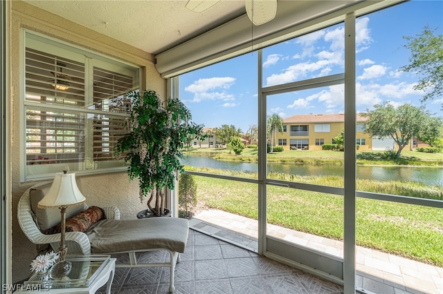 sunroom / solarium with a water view