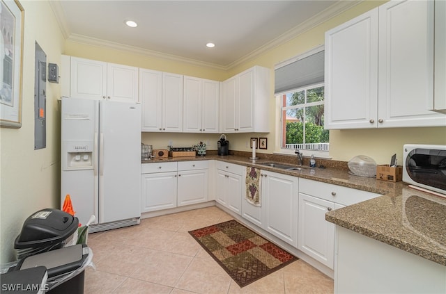 kitchen with white cabinetry, light tile floors, white appliances, and stone countertops